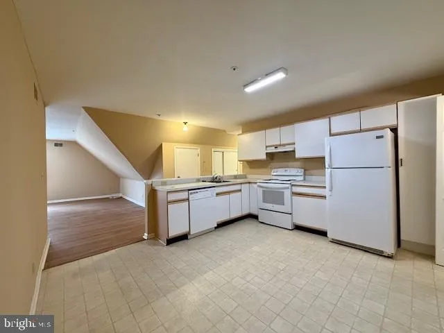 a view of kitchen and kitchen with furniture