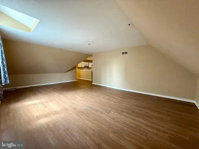 a view of an empty room and wooden floor