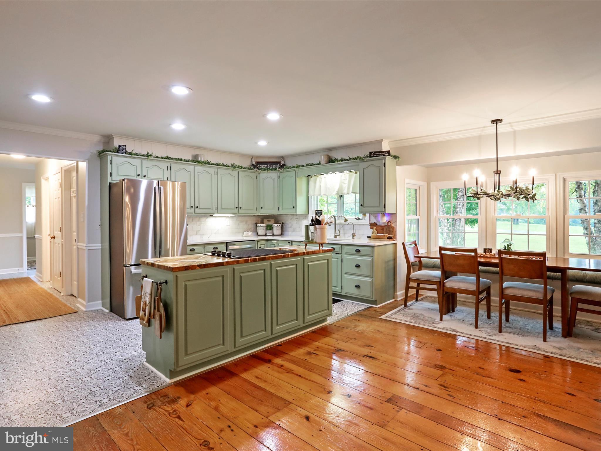 535 Bowling View Road Front Royal, VA 22630 - Photo 13 of 53 a kitchen with stainless steel appliances kitchen island granite countertop a refrigerator a stove a sink dishwasher and white cabinets with wooden floor