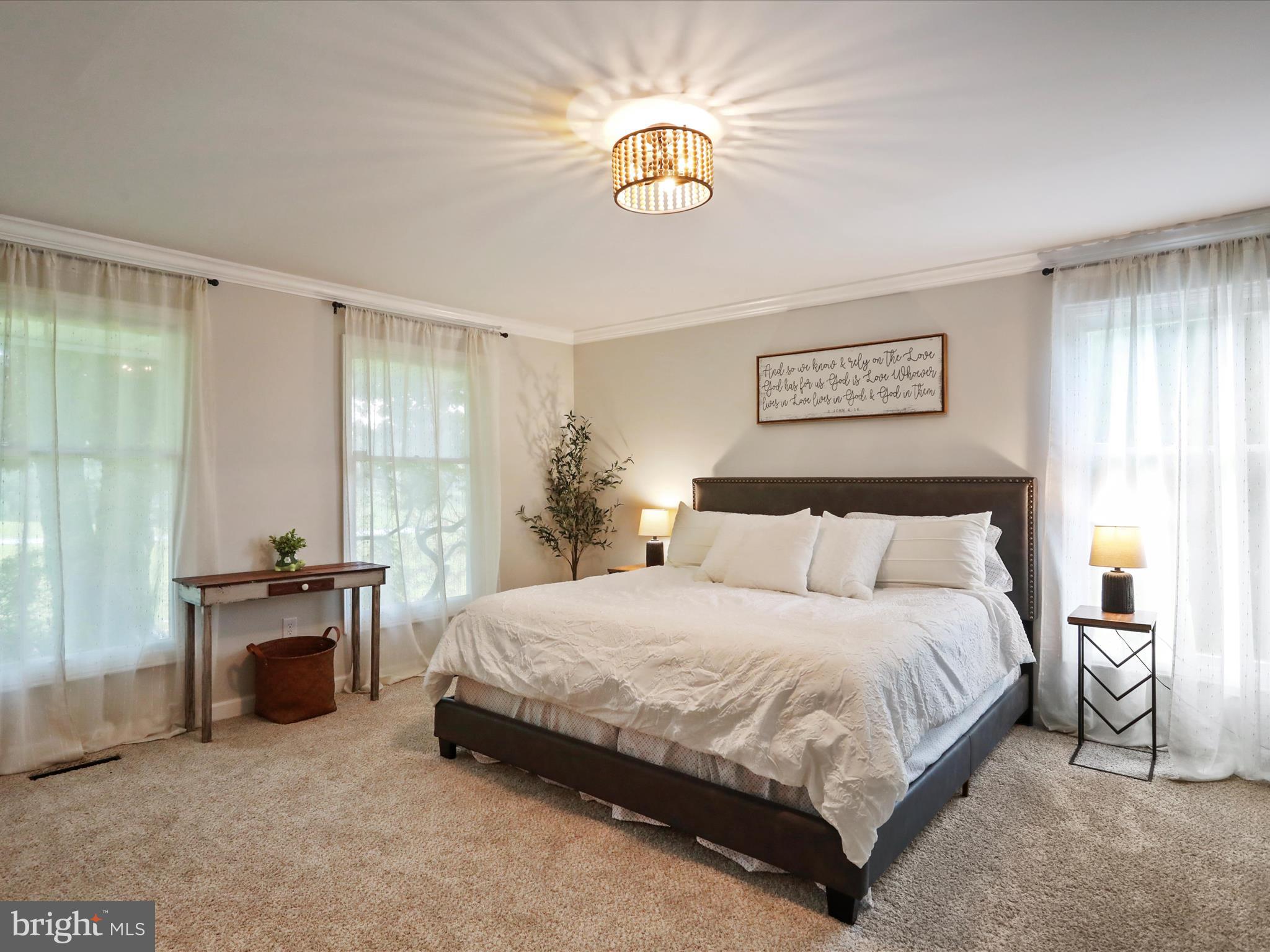 535 Bowling View Road Front Royal, VA 22630 - Photo 31 of 53 a bedroom with a bed and a chandelier
