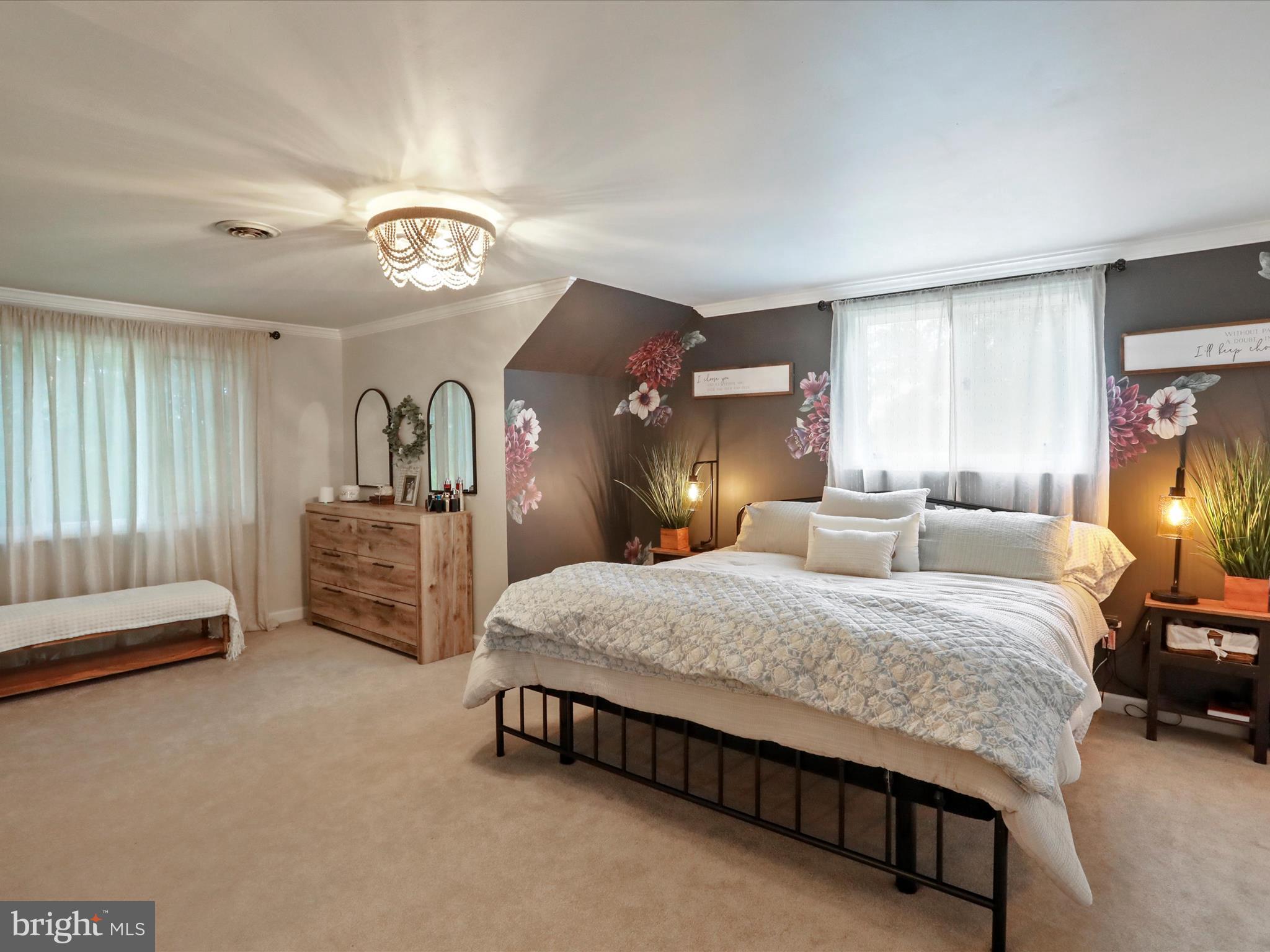 535 Bowling View Road Front Royal, VA 22630 - Photo 40 of 53 a spacious bedroom with a bed a chandelier and dresser