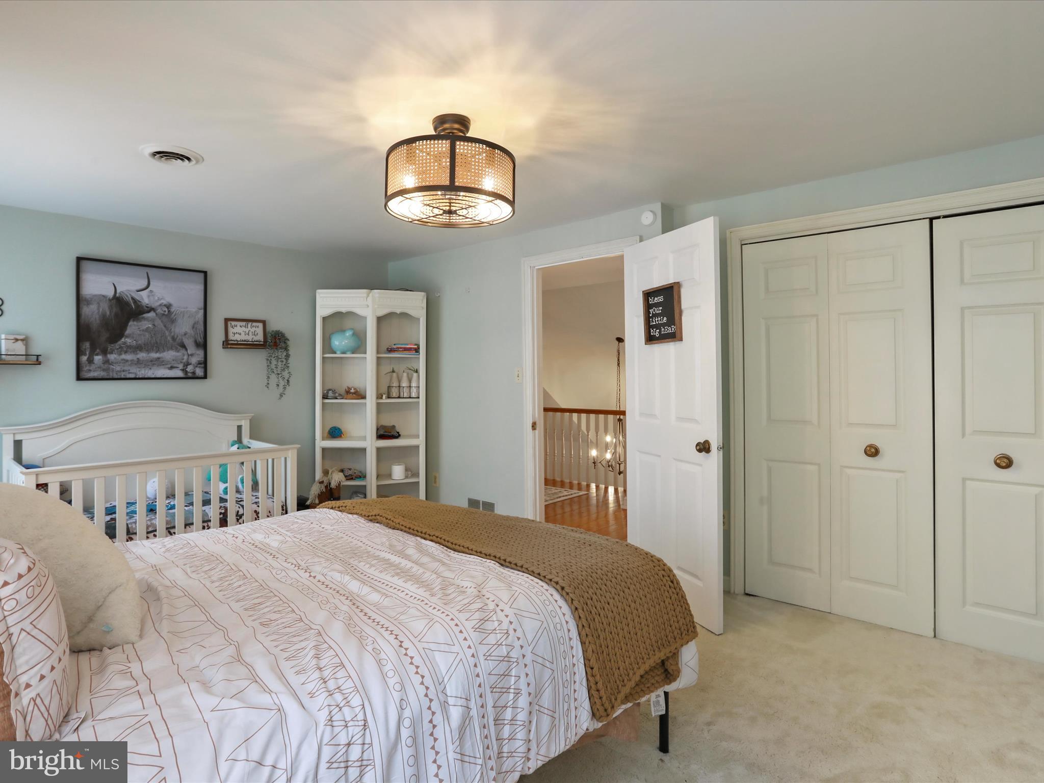 535 Bowling View Road Front Royal, VA 22630 - Photo 44 of 53 a bedroom with a large bed and a chandelier