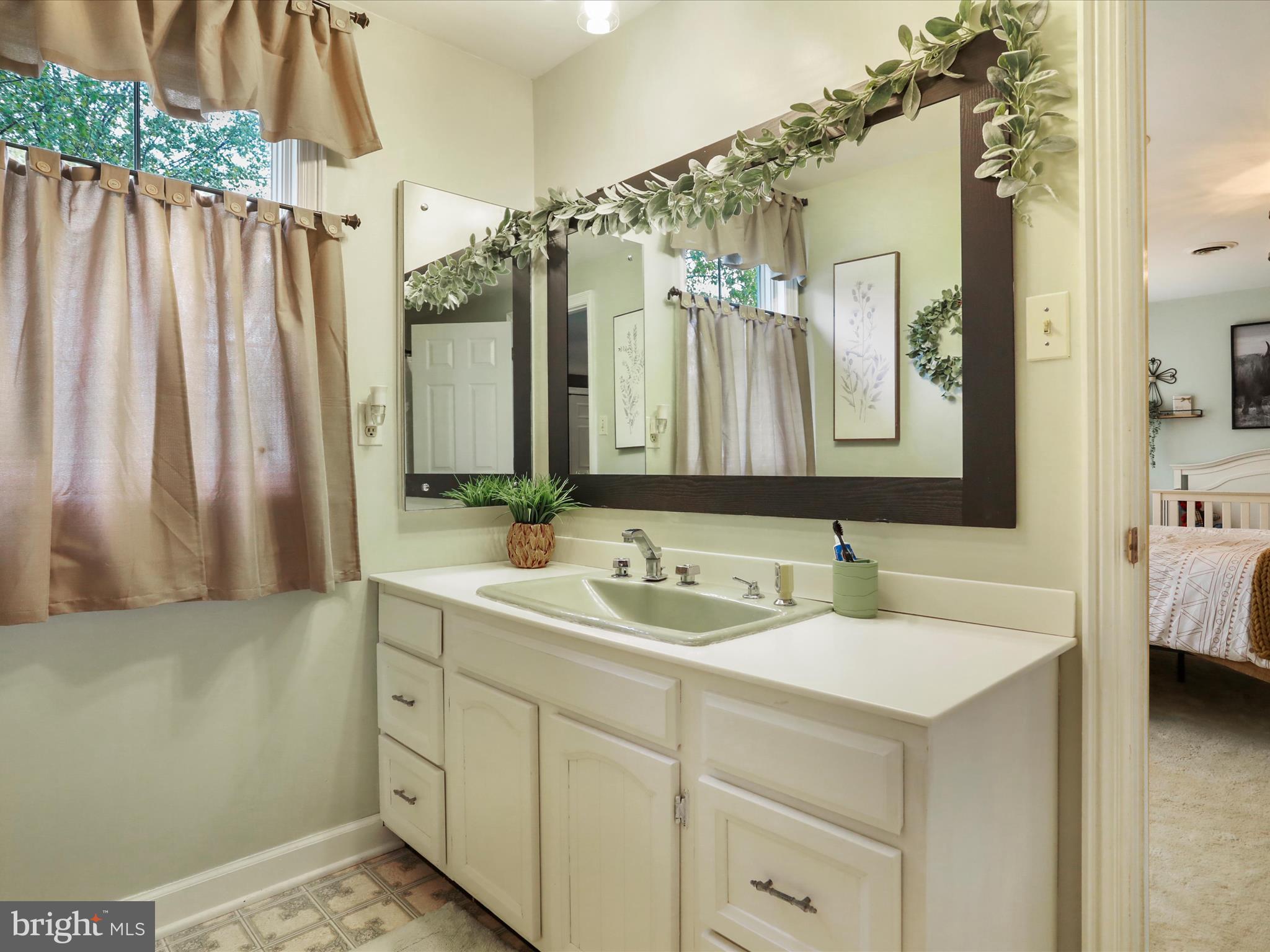 535 Bowling View Road Front Royal, VA 22630 - Photo 46 of 53 a bathroom with a double vanity sink and a mirror