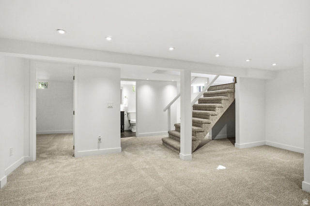 1187 East Ridgedale Circle Millcreek, UT 84106 - Photo 20 of 49 Carpeted lower level with recessed lighting, a carpeted staircase with white railings, and white walls