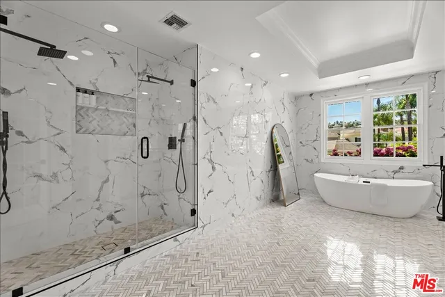 a bathroom with a bathtub and a shower