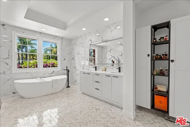 a bathroom with a bathtub sink and mirror