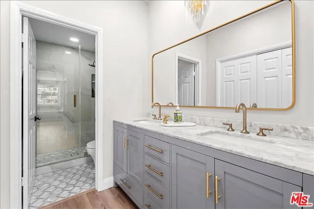 a bathroom with a granite countertop sink mirror and double