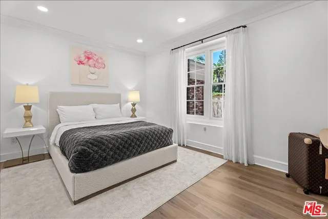 a spacious bedroom with a bed and a window