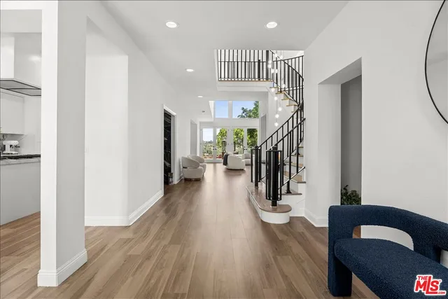a view of entryway and hall with wooden floor