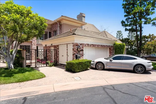 a view of a swimming pool with a table and chairs under an umbrella