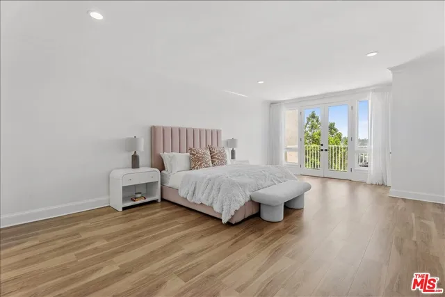 a spacious bedroom with a bed and a couch