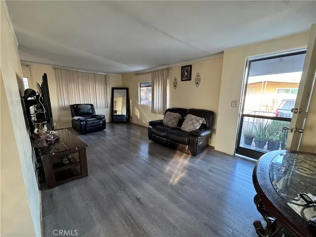 a living room with furniture window and a wooden floor
