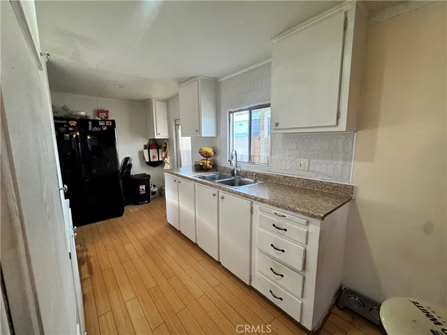 a kitchen with cabinets appliances and a window