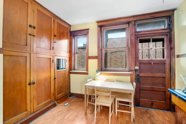 a dining room with a wooden table and chairs