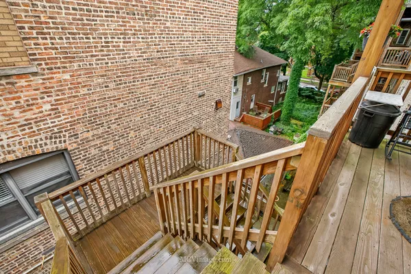 a view of balcony with wooden floor and fence