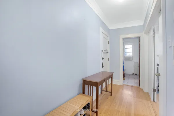a view of a hallway with wooden floor and a hallway