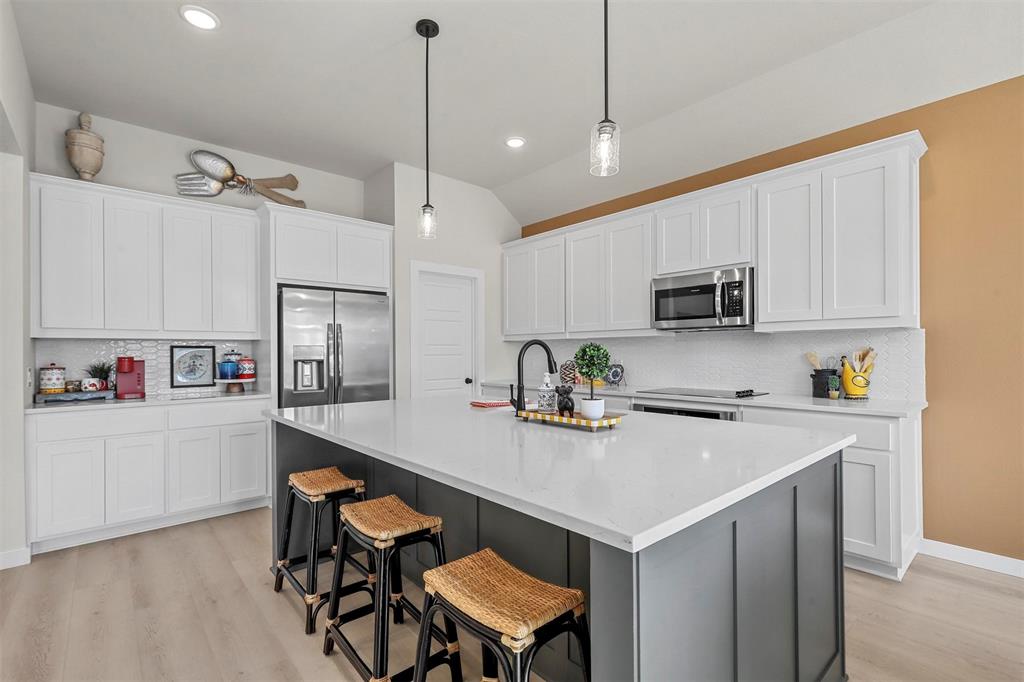 147 Rj Smith Drive Boyd, TX 76023 - Photo 5 of 15 a kitchen that has a cabinets a sink and chairs