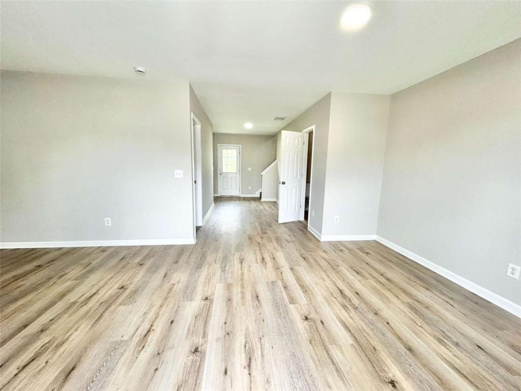 739 Wheel House Lane, Unit A Monroe, GA 30655 - Photo 3 of 17 a view of empty room with wooden floor