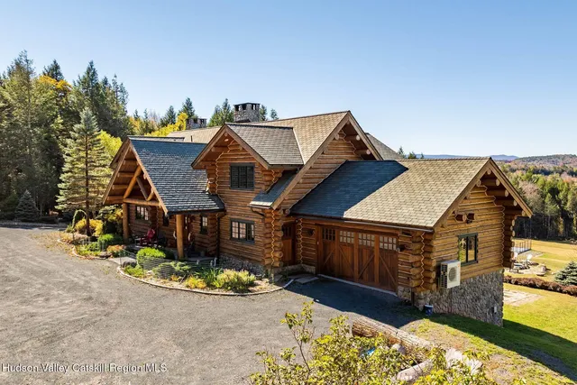 a kitchen with stainless steel appliances granite countertop a sink a stove and wooden cabinets