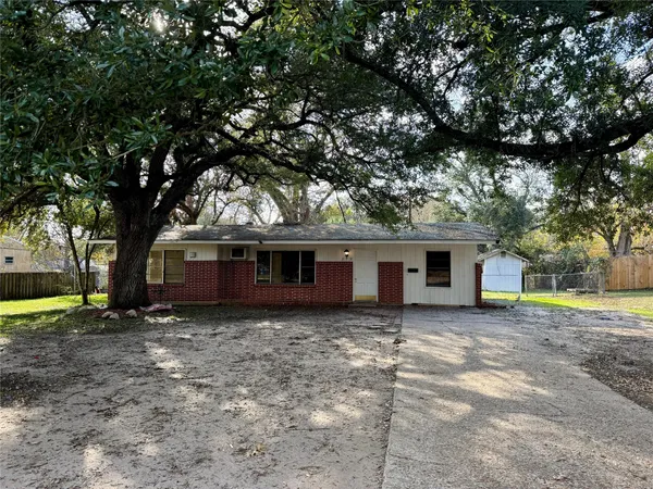 a house that has a tree in front of it