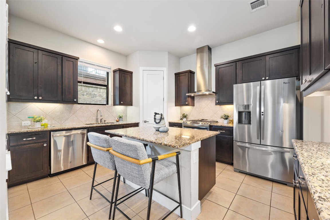405 Penny Kathleen Court Austin, TX 78717 - Photo 11 of 30 a kitchen with stainless steel appliances granite countertop a refrigerator and a stove top oven