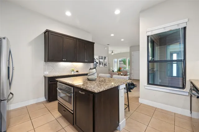 a kitchen with stainless steel appliances granite countertop a sink and a stove