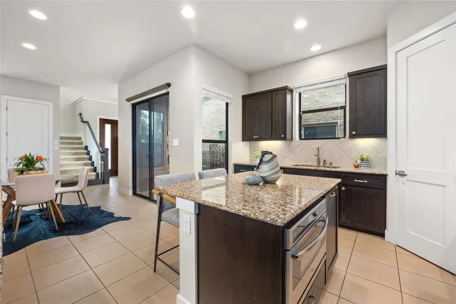 a kitchen with a sink refrigerator and cabinets