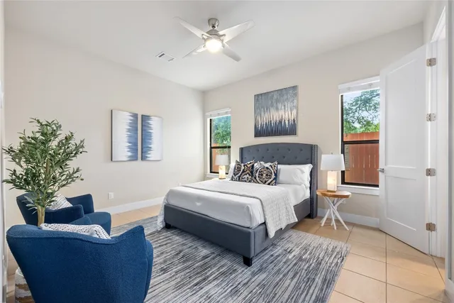 a bedroom with a large bed and a couch