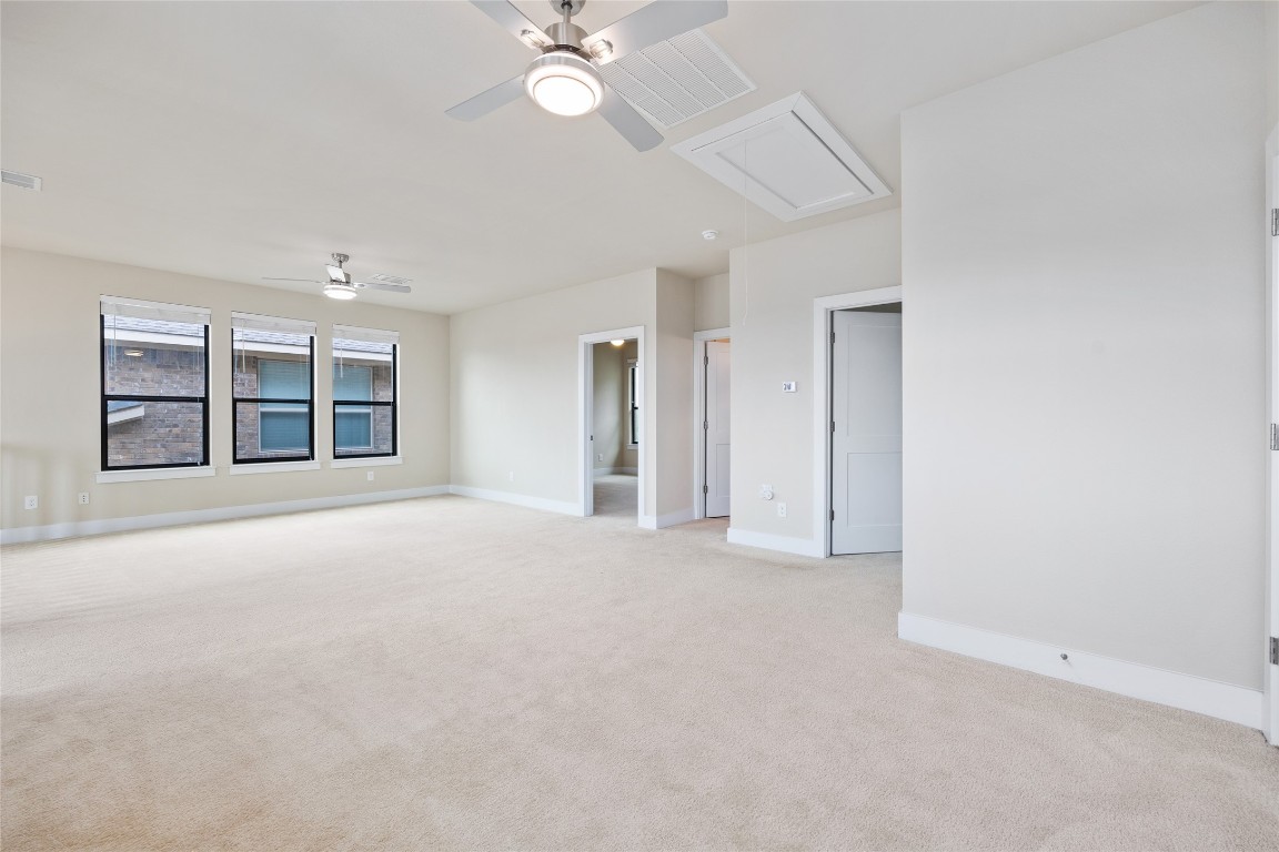 405 Penny Kathleen Court Austin, TX 78717 - Photo 23 of 30 an empty room with chandelier fan and windows