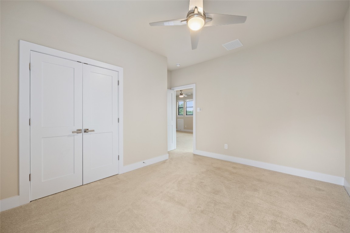 405 Penny Kathleen Court Austin, TX 78717 - Photo 25 of 30 an empty room with a ceiling fan and a window