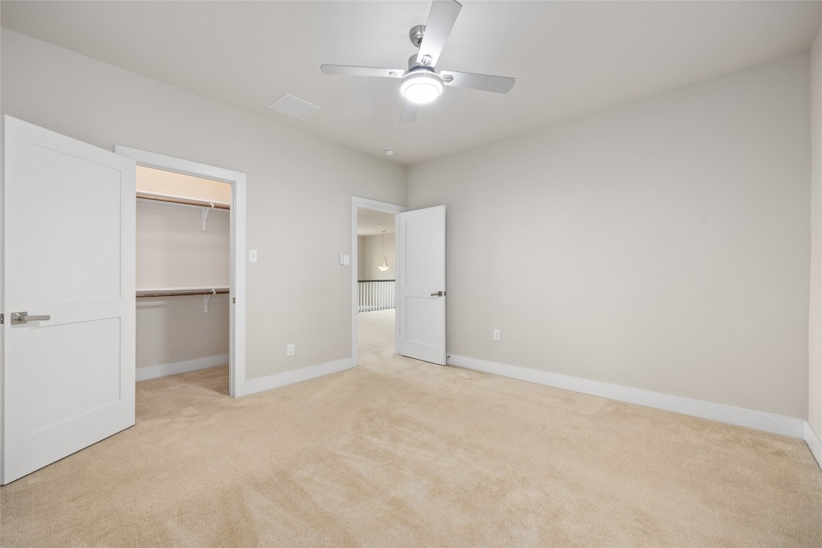 405 Penny Kathleen Court Austin, TX 78717 - Photo 28 of 30 a view of an empty room with a ceiling fan