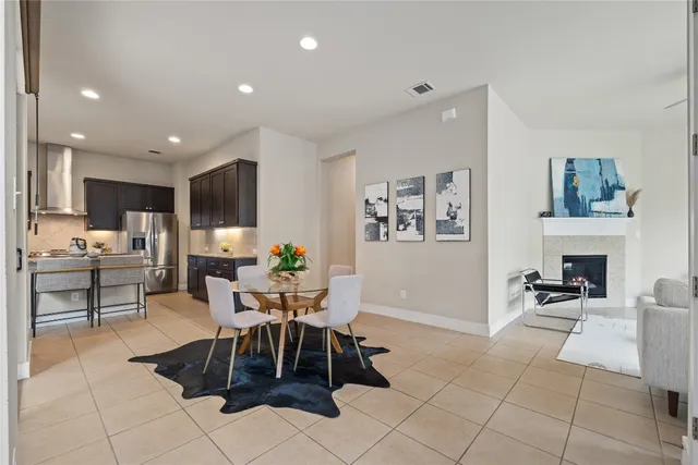 a living room with furniture a dining table and a fireplace