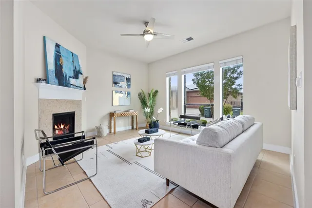 a living room with furniture fireplace and a large window