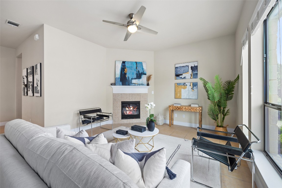 405 Penny Kathleen Court Austin, TX 78717 - Photo 6 of 30 a living room with furniture a fireplace and a flat screen tv