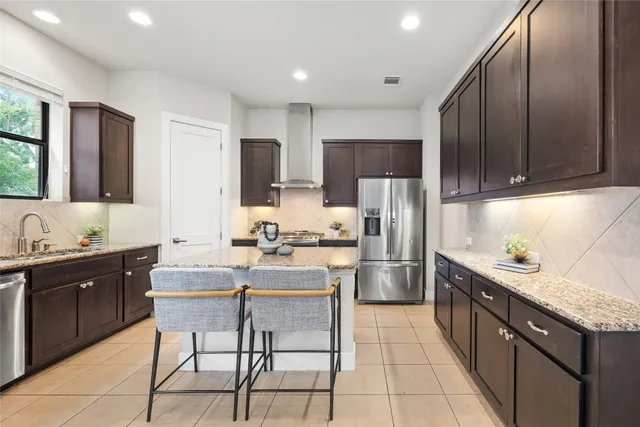a kitchen with refrigerator and cabinets