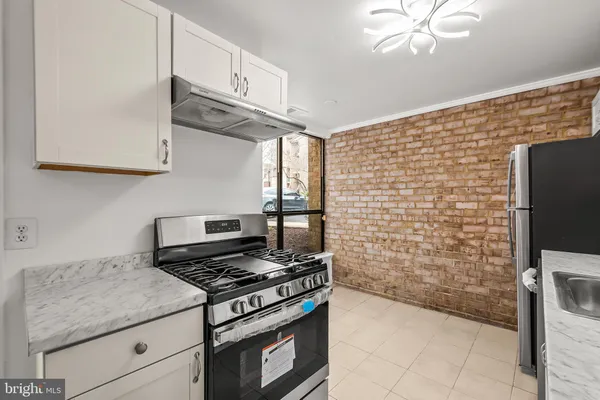 a kitchen with stainless steel appliances granite countertop a stove and a refrigerator