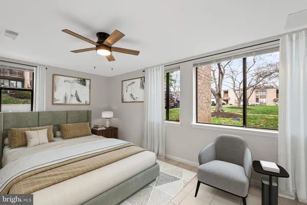 a bedroom with a large bed and a couch
