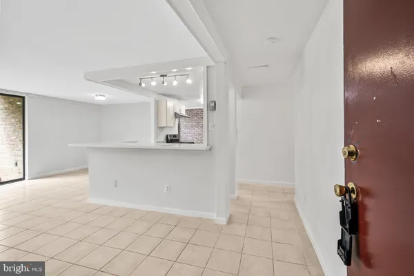 a view of a kitchen with marble kitchen and refrigerator