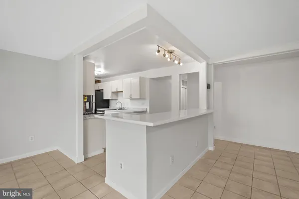 a open kitchen with cabinets and stainless steel appliances