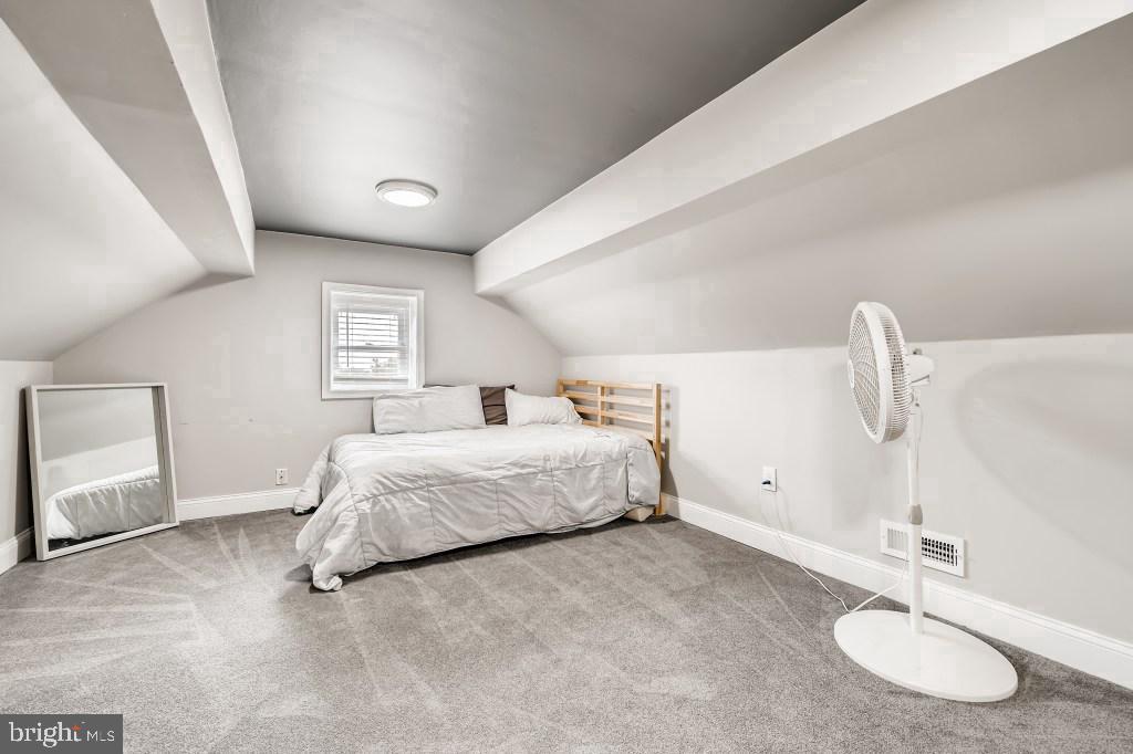 827 University Boulevard West Silver Spring, MD 20901 - Photo 12 of 40 a spacious bedroom with a bed and a table