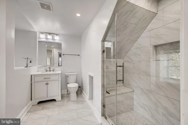 a spacious bathroom with a toilet sink and shower