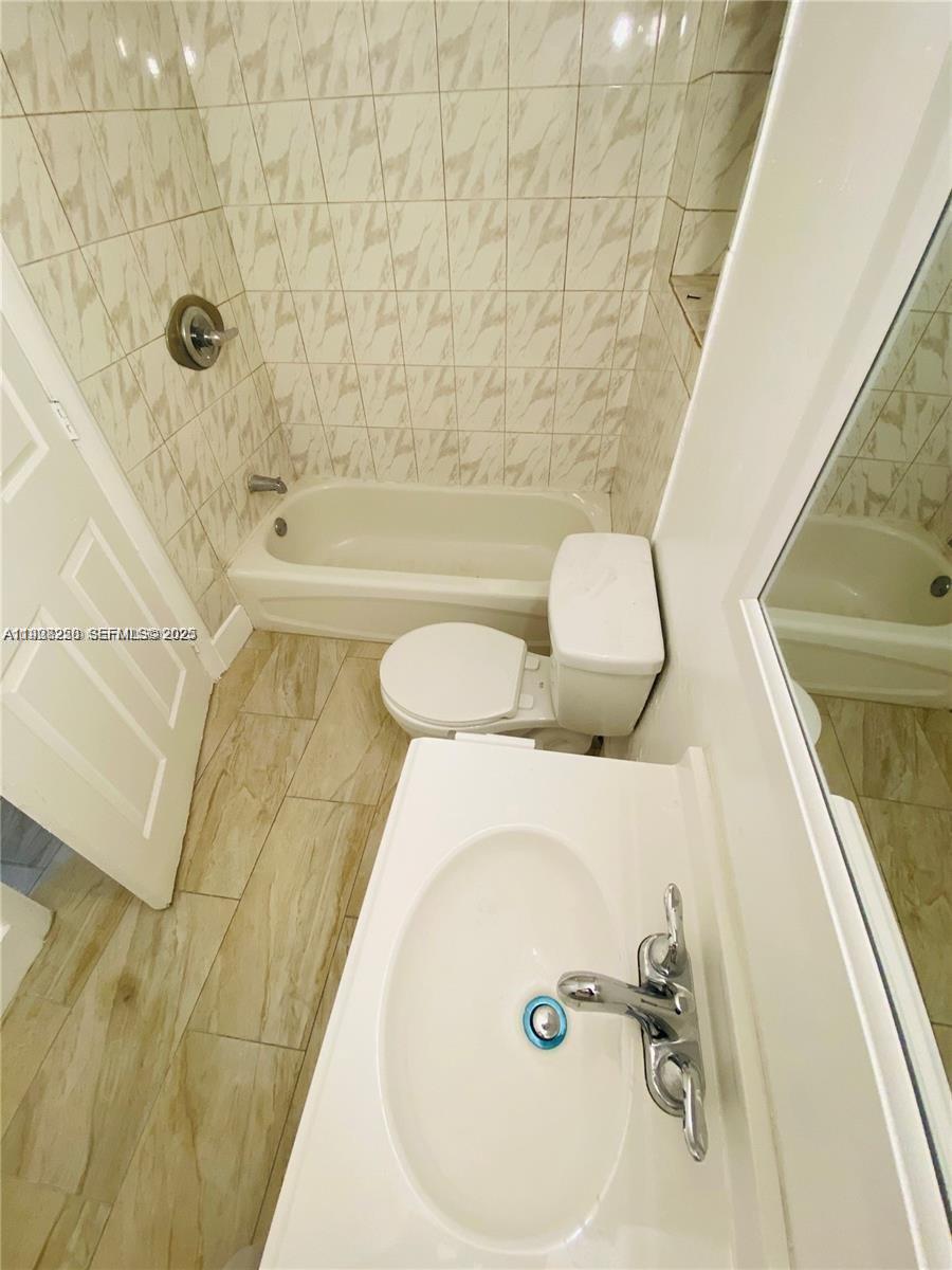 2230 Northwest 51st Terrace, Unit 2 Miami, FL 33142 - Photo 6 of 10 a bathroom with a sink and a bathtub