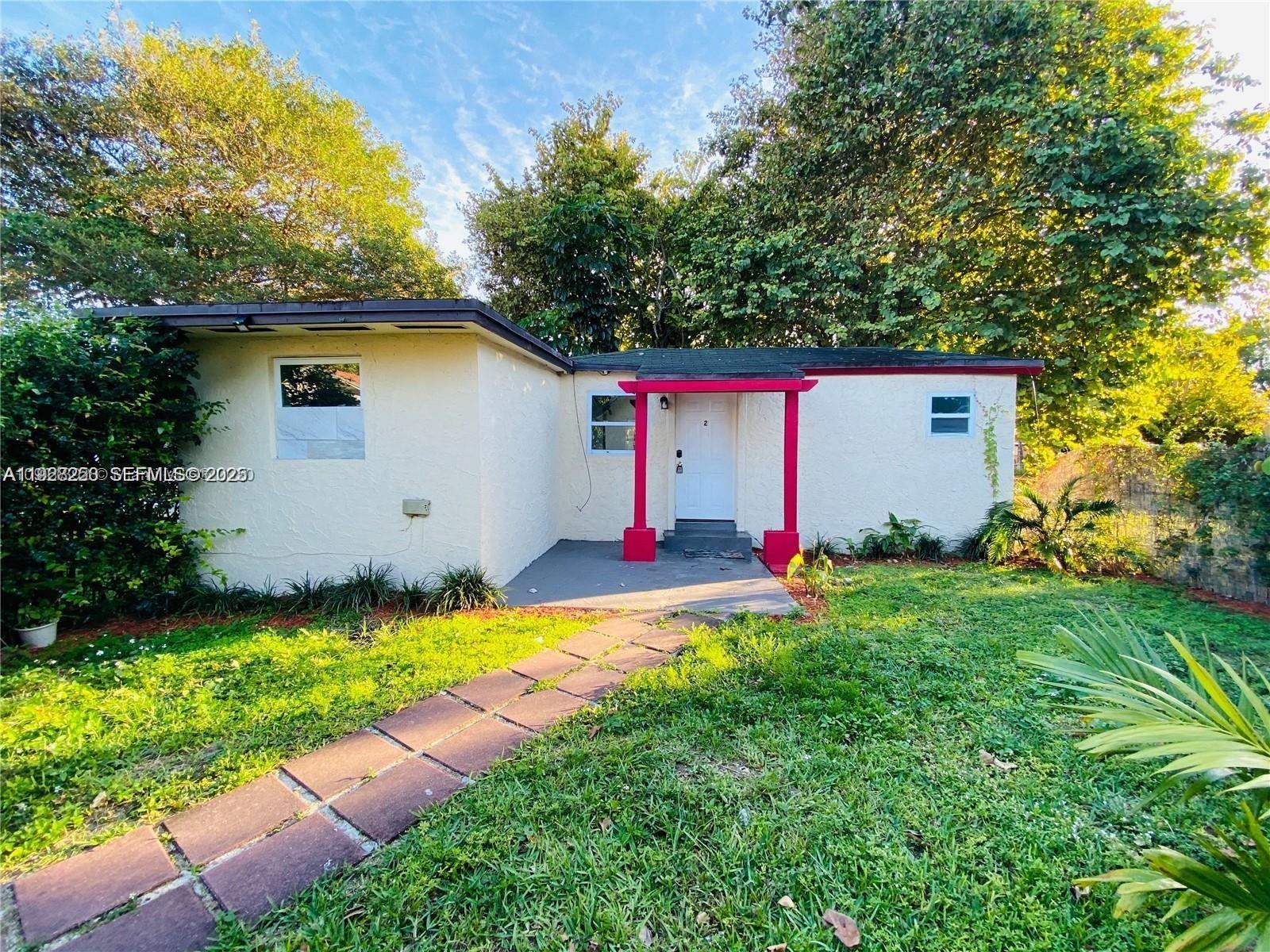 2230 Northwest 51st Terrace, Unit 2 Miami, FL 33142 - Photo 9 of 10 a front view of house with yard and swimming pool