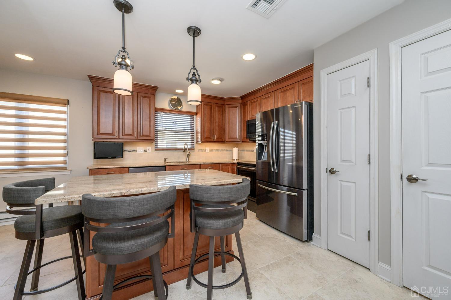 3 Bow Drive Brick, NJ 08723 - Photo 14 of 36 a kitchen with stainless steel appliances granite countertop a refrigerator a sink a stove and a cabinets