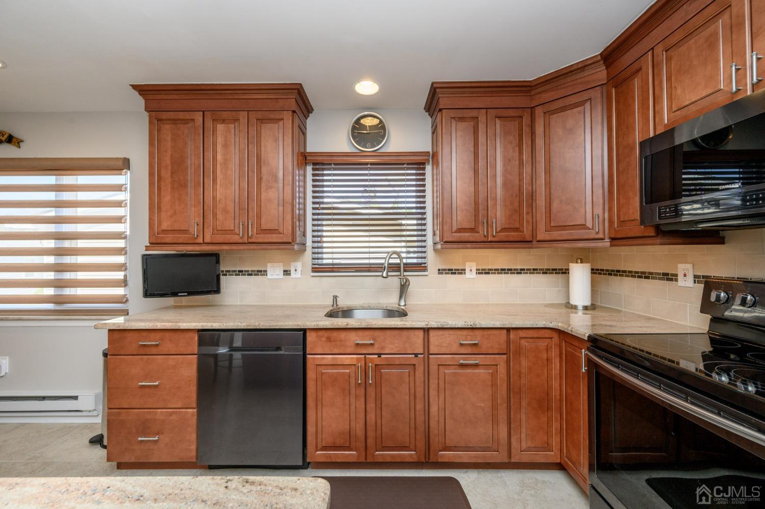 3 Bow Drive Brick, NJ 08723 - Photo 15 of 36 a kitchen with granite countertop wooden cabinets and a stove top oven