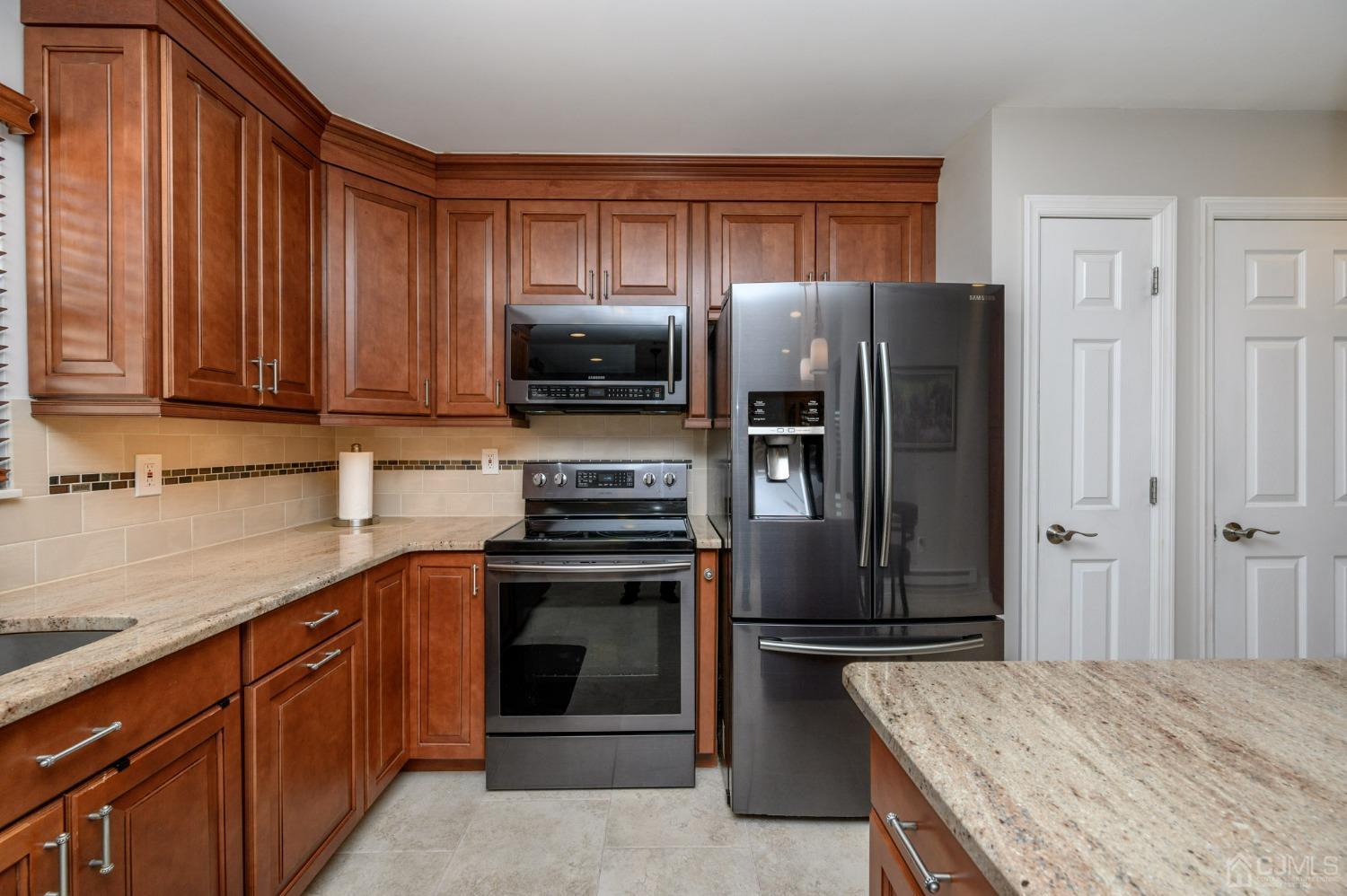 3 Bow Drive Brick, NJ 08723 - Photo 16 of 36 a kitchen with stainless steel appliances granite countertop a refrigerator stove and sink