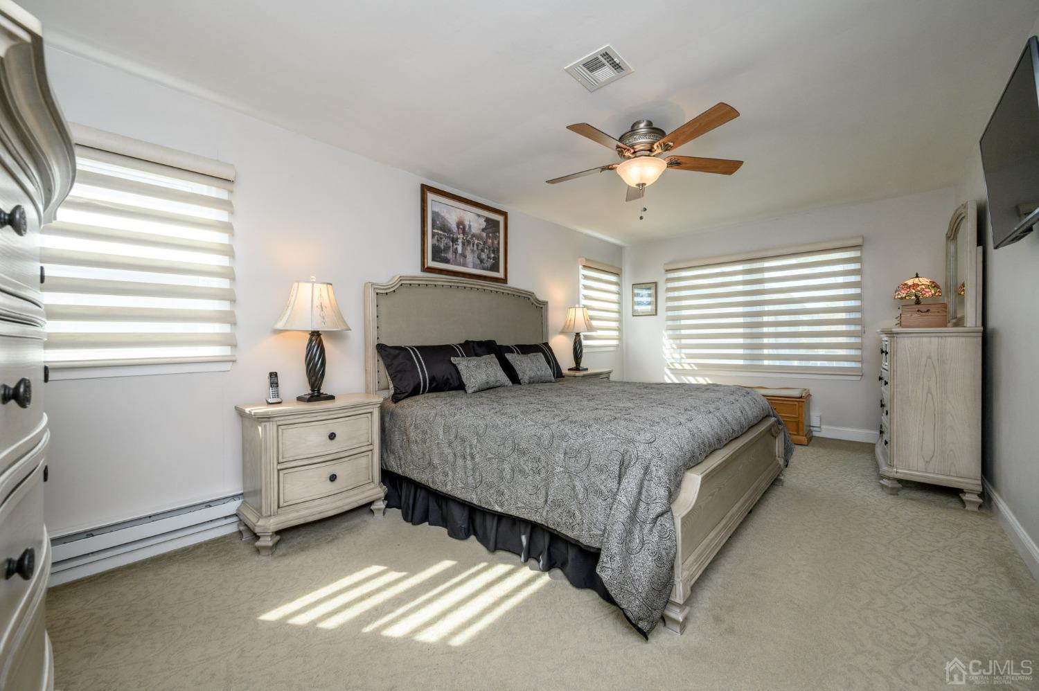 3 Bow Drive Brick, NJ 08723 - Photo 18 of 36 a bedroom with a bed and a chandelier