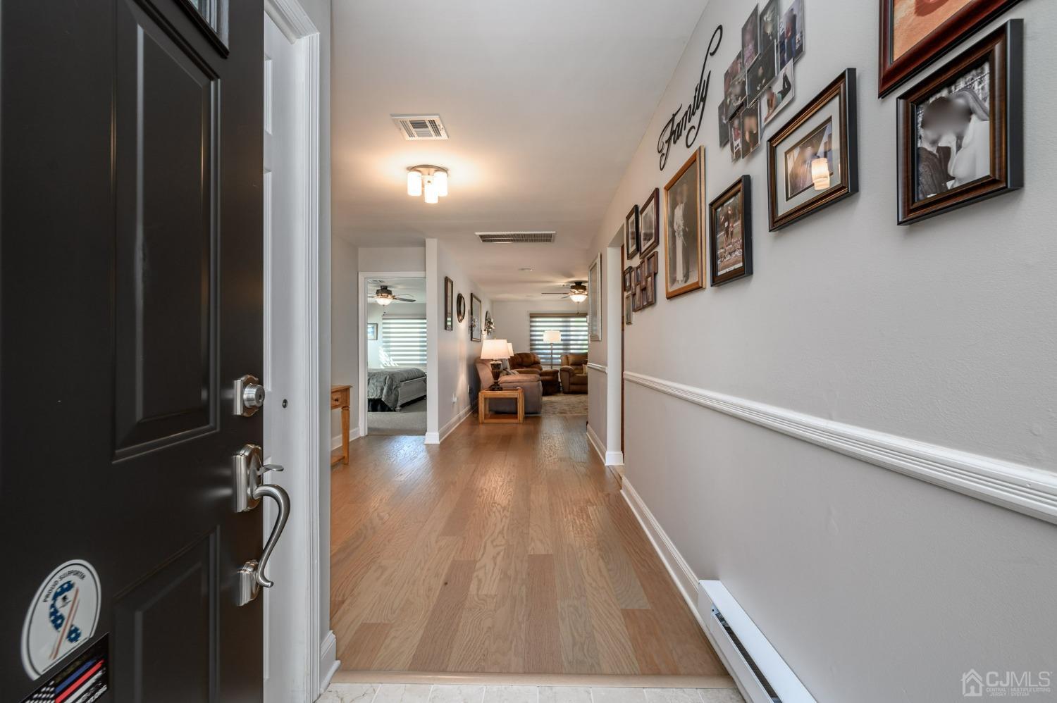 3 Bow Drive Brick, NJ 08723 - Photo 3 of 36 a view of a hallway with wooden floor and stairs