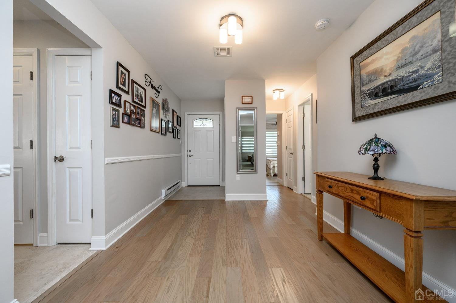 3 Bow Drive Brick, NJ 08723 - Photo 4 of 36 a view of a hallway view with wooden floor and staircase