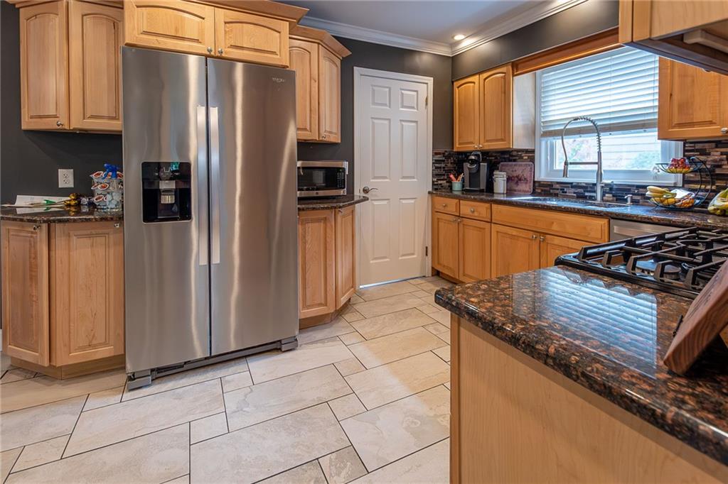 357 Carley Avenue Sharon, PA 16146 - Photo 11 of 32 a kitchen with stainless steel appliances granite countertop a refrigerator and a sink